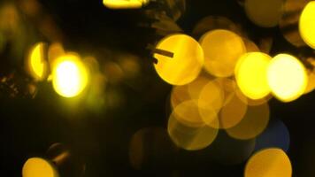 Abstract festive yellow-orange lights with bokeh, sparkling circular stars motion. Holiday concept backdrop. Holiday concept backdrop with twinkling bright shapes. Blinking Christmas Tree lights video
