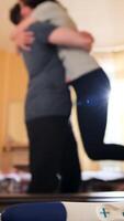 cerca arriba de positivo el embarazo prueba acostado en un mesa y mujer abrazando un hombre. valores imágenes. contento marido abrazando su embarazada esposa en el habitación, familia concepto. video